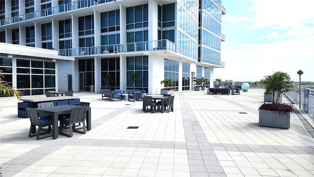 view of community featuring a patio and outdoor dining space