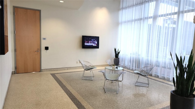 interior space with recessed lighting and speckled floor