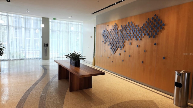 home office featuring a wall of windows and speckled floor