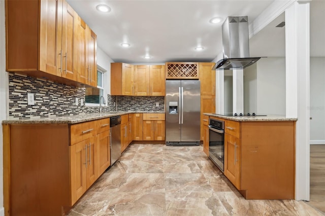 kitchen featuring stainless steel appliances, decorative backsplash, a sink, island range hood, and light stone countertops