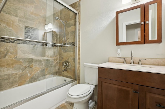 bathroom with enclosed tub / shower combo, vanity, and toilet