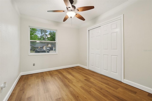 unfurnished bedroom featuring baseboards and wood finished floors