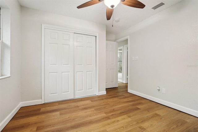 unfurnished bedroom featuring visible vents, light wood-style flooring, and baseboards