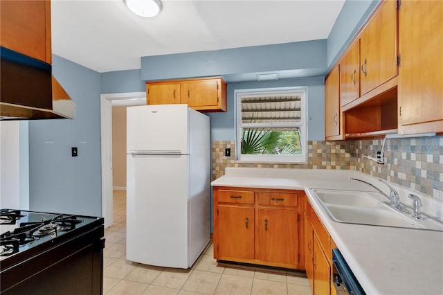 kitchen with black appliances, a sink, light countertops, and decorative backsplash