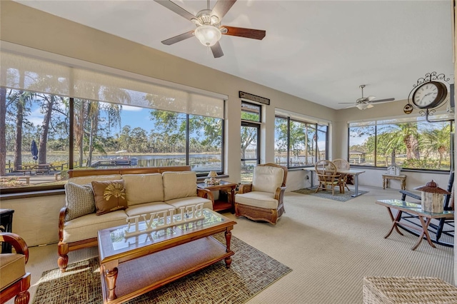 sunroom / solarium featuring a ceiling fan