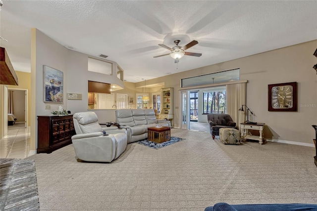 living room with light carpet, a textured ceiling, and ceiling fan