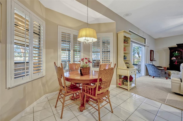 dining area featuring baseboards and tile patterned flooring