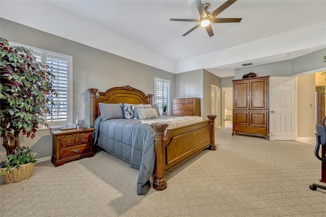 bedroom with multiple windows, light colored carpet, and baseboards