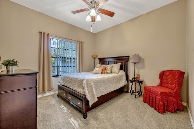 carpeted bedroom featuring a ceiling fan and baseboards