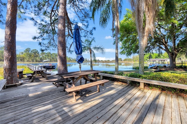 deck with a water view and a dock