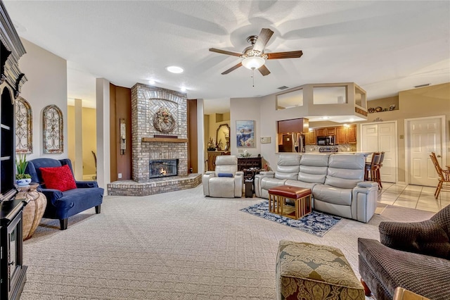 living area with a brick fireplace, light carpet, visible vents, and ceiling fan