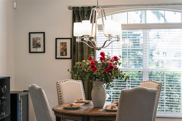 dining space with water heater and an inviting chandelier