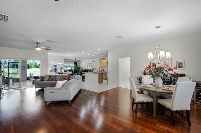 living area featuring visible vents, recessed lighting, a textured ceiling, and light wood-style floors