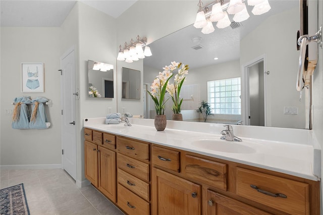 full bath with tile patterned floors, double vanity, visible vents, and a sink