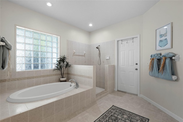 bathroom with tile patterned floors, a garden tub, a walk in shower, recessed lighting, and baseboards