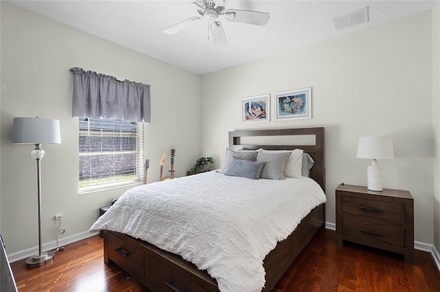 bedroom featuring dark wood finished floors, visible vents, a ceiling fan, and baseboards