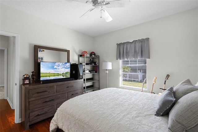 bedroom featuring dark wood finished floors and ceiling fan