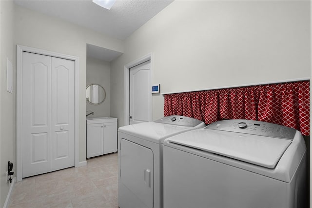 laundry area featuring cabinet space, a textured ceiling, and independent washer and dryer