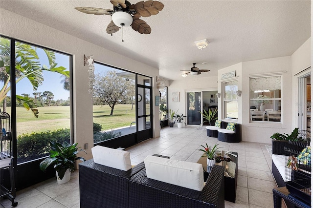 sunroom with ceiling fan