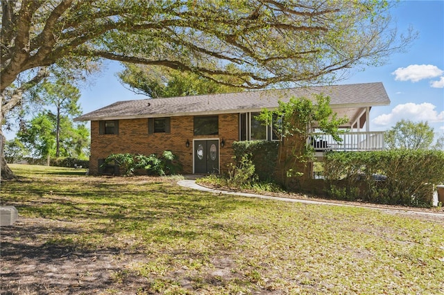 view of front of property with a front yard and brick siding