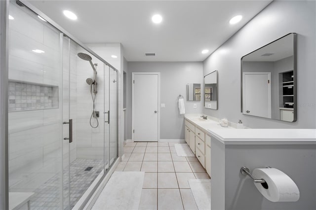 bathroom featuring visible vents, double vanity, recessed lighting, a stall shower, and tile patterned flooring