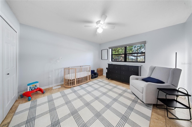 bedroom featuring a closet, a ceiling fan, and baseboards