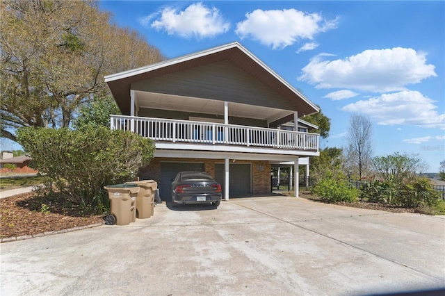 view of front facade featuring concrete driveway, brick siding, and a garage