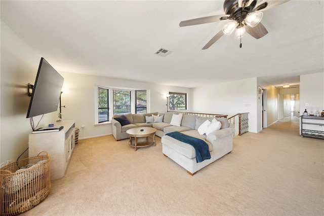 13224 Casper Ln, Clermont, FL 34711 - living room featuring a ceiling fan, baseboards, visible vents, and light colored carpet