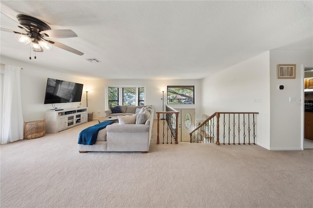 13224 Casper Ln, Clermont, FL 34711 - carpeted living area featuring visible vents, ceiling fan, and a textured ceiling