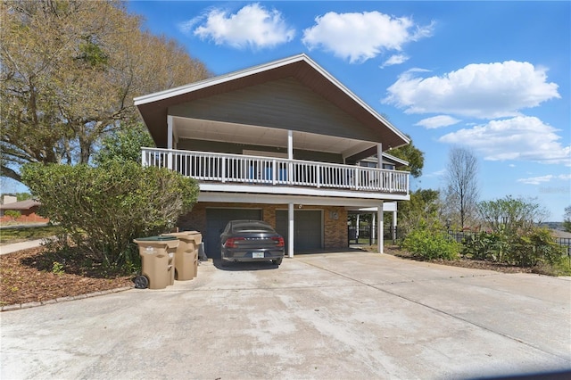 13224 Casper Ln, Clermont, FL 34711 - view of front facade featuring an attached garage, brick siding, driveway, and a balcony