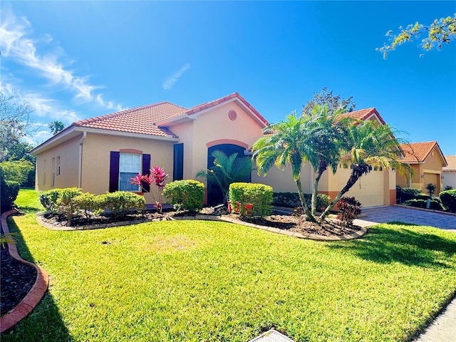 mediterranean / spanish-style home with stucco siding, a front lawn, a tile roof, and a garage