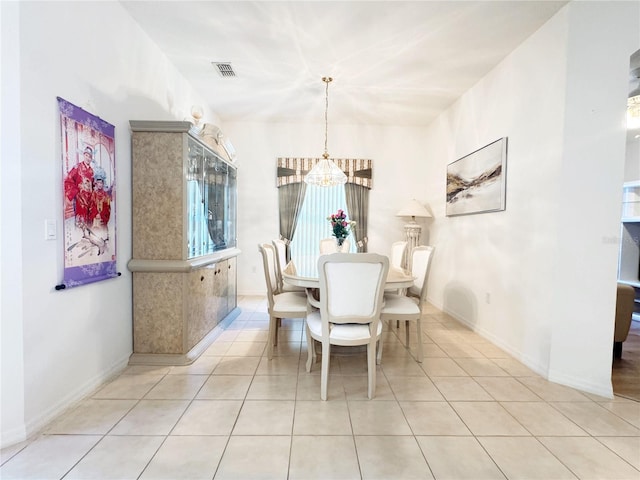 dining area featuring visible vents, baseboards, a notable chandelier, and tile patterned flooring