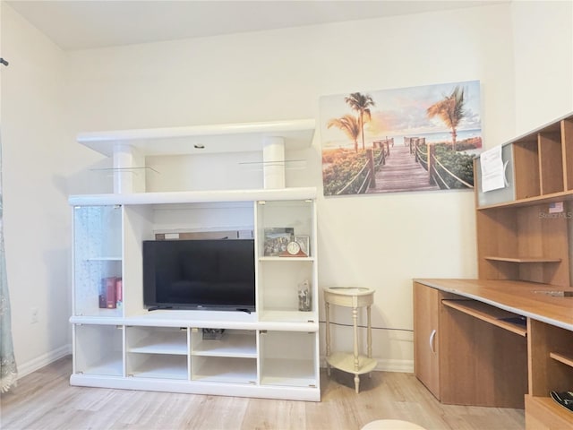 living room featuring baseboards and light wood-style flooring