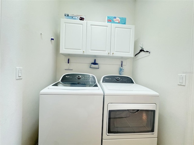 laundry area with washer and dryer and cabinet space