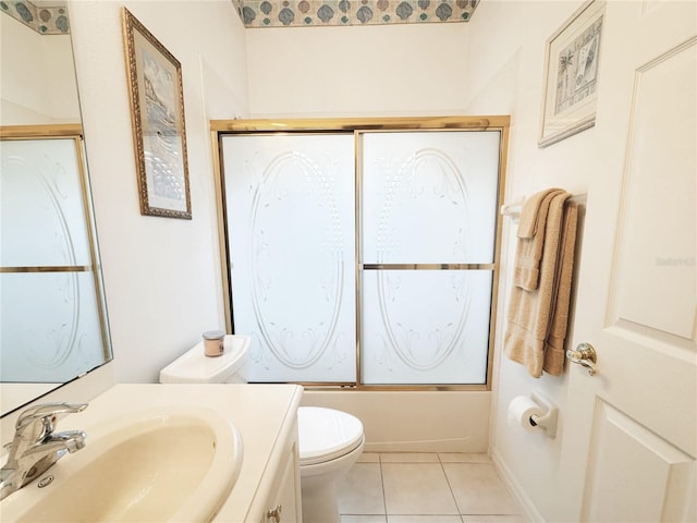 full bath featuring vanity, toilet, shower / bath combination with glass door, and tile patterned flooring