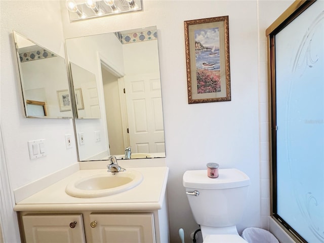 full bathroom with toilet and vanity