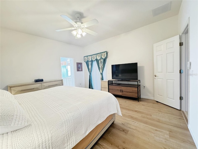 bedroom with visible vents, ceiling fan, baseboards, and light wood-style floors