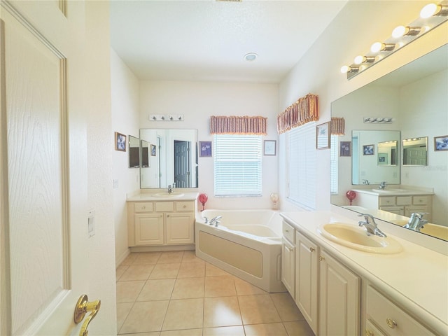 full bath with a sink, two vanities, a bath, and tile patterned flooring