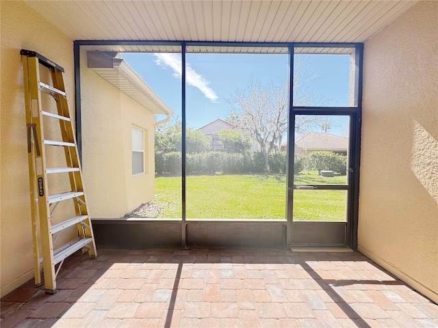 unfurnished sunroom with wooden ceiling