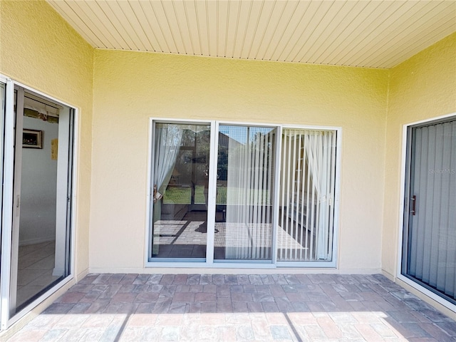 doorway to property with stucco siding