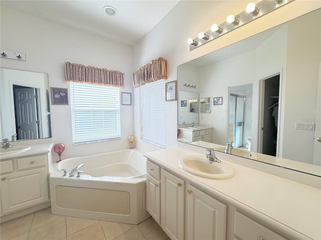 full bath featuring a sink, a bath, a shower stall, and tile patterned flooring