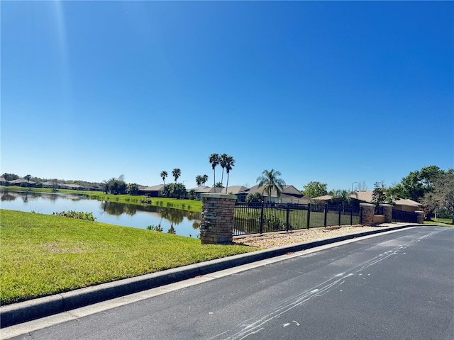 property view of water featuring fence