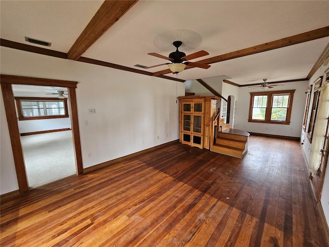 unfurnished living room featuring baseboards, beamed ceiling, visible vents, and hardwood / wood-style flooring