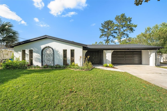 ranch-style house with a front yard, an attached garage, driveway, and stucco siding