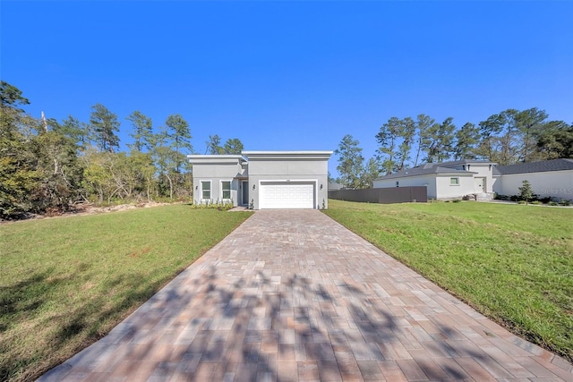 view of front facade with a garage, stucco siding, decorative driveway, and a front yard