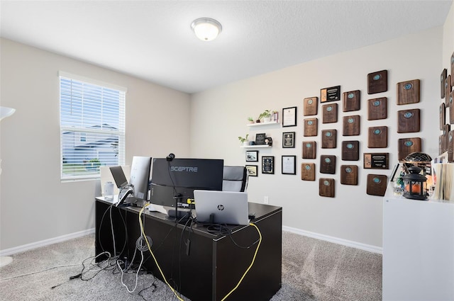 home office with baseboards, carpet, and a textured ceiling