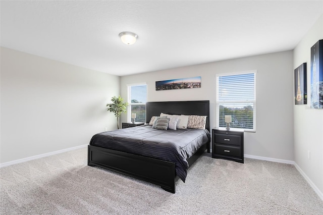 bedroom featuring multiple windows, carpet, and baseboards