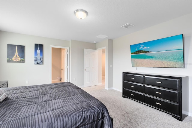 carpeted bedroom with visible vents and baseboards