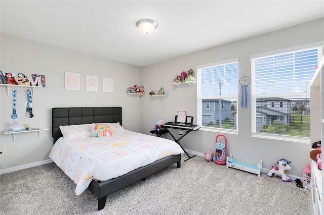 bedroom with baseboards and carpet