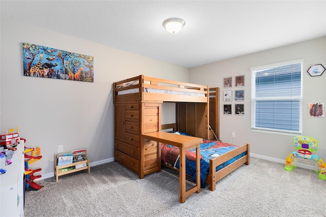 carpeted bedroom featuring baseboards